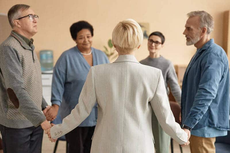 Men and Women Holding Hands and Praying at Trinity Lutheran Church